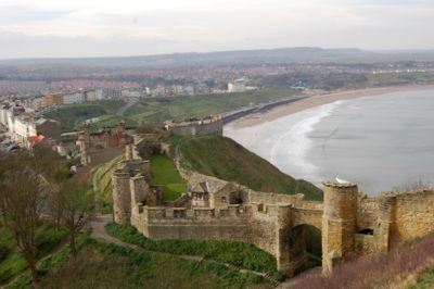 The barbican, or main gateway, today, close to a stone archway. The view is towards Scarborough's North Bay.